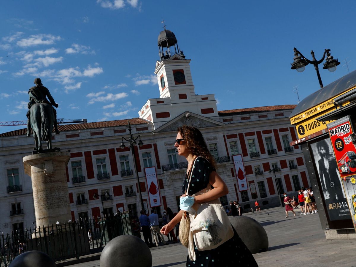 Photo: A woman walks through the Puerta del Sol in Madrid.  (Reuters)