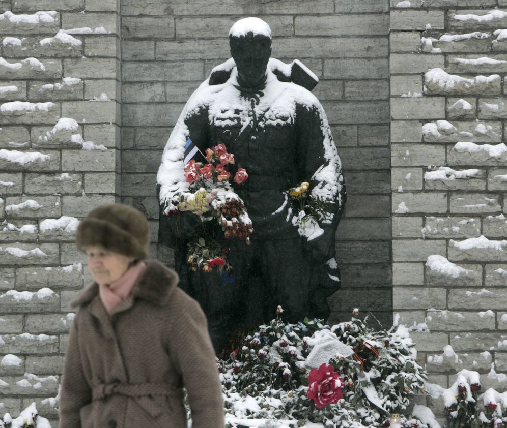 Foto: Una mujer pasa por delante de la Estatua del Soldado de Bronce antes de su retirada, en Tallin, febrero de 2007. (Reuters)